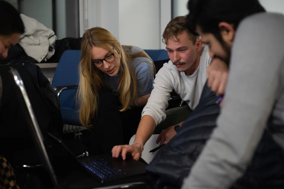 Enactus Munich members working together at a laptop during a Celonis workshop