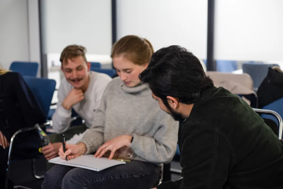 Members writing notes together during a Celonis workshop