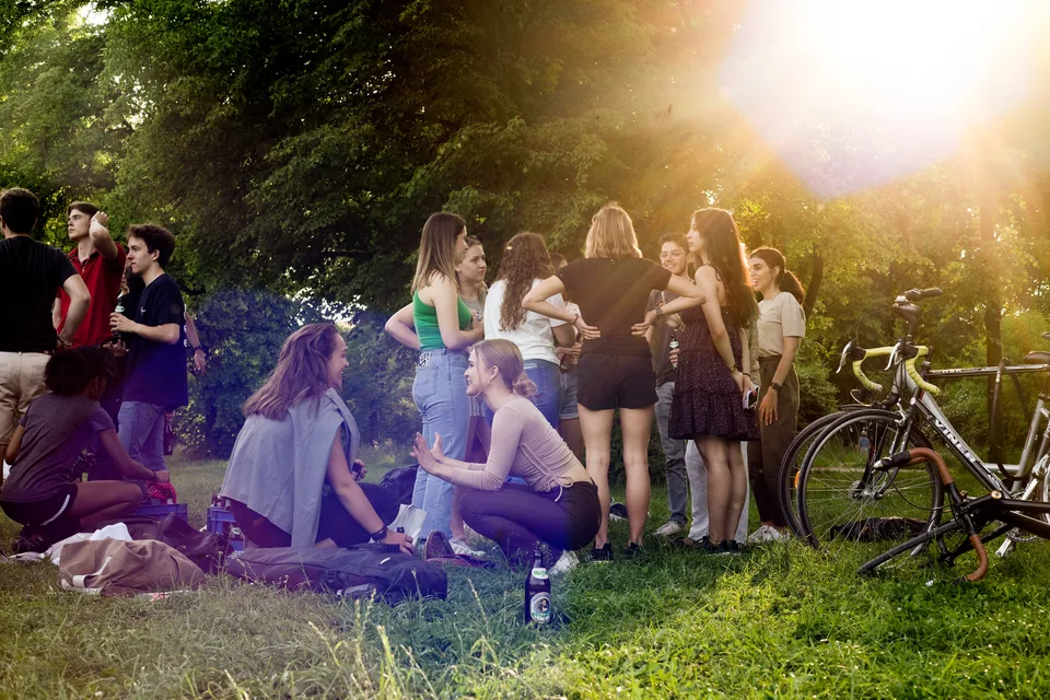 Enactus Munich members spending time together in the park at golden hour