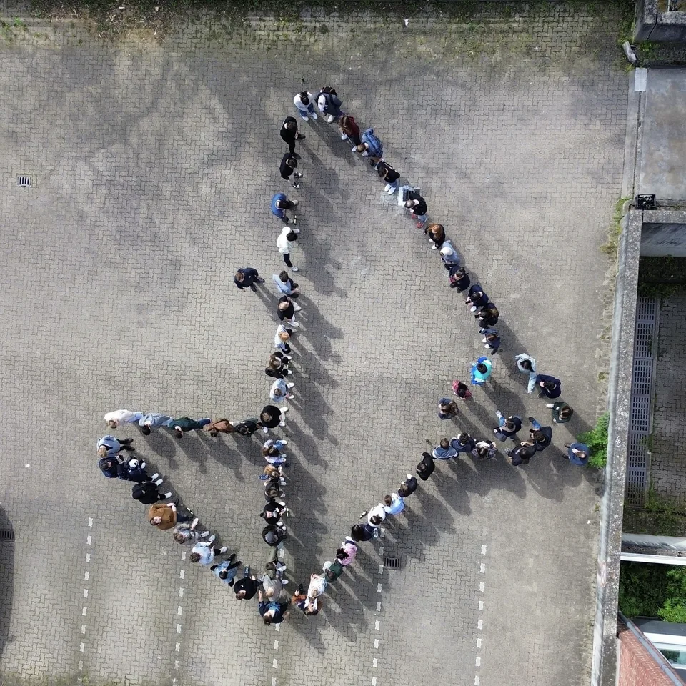 Enactus Munich members forming the Enactus arrow, seen from above